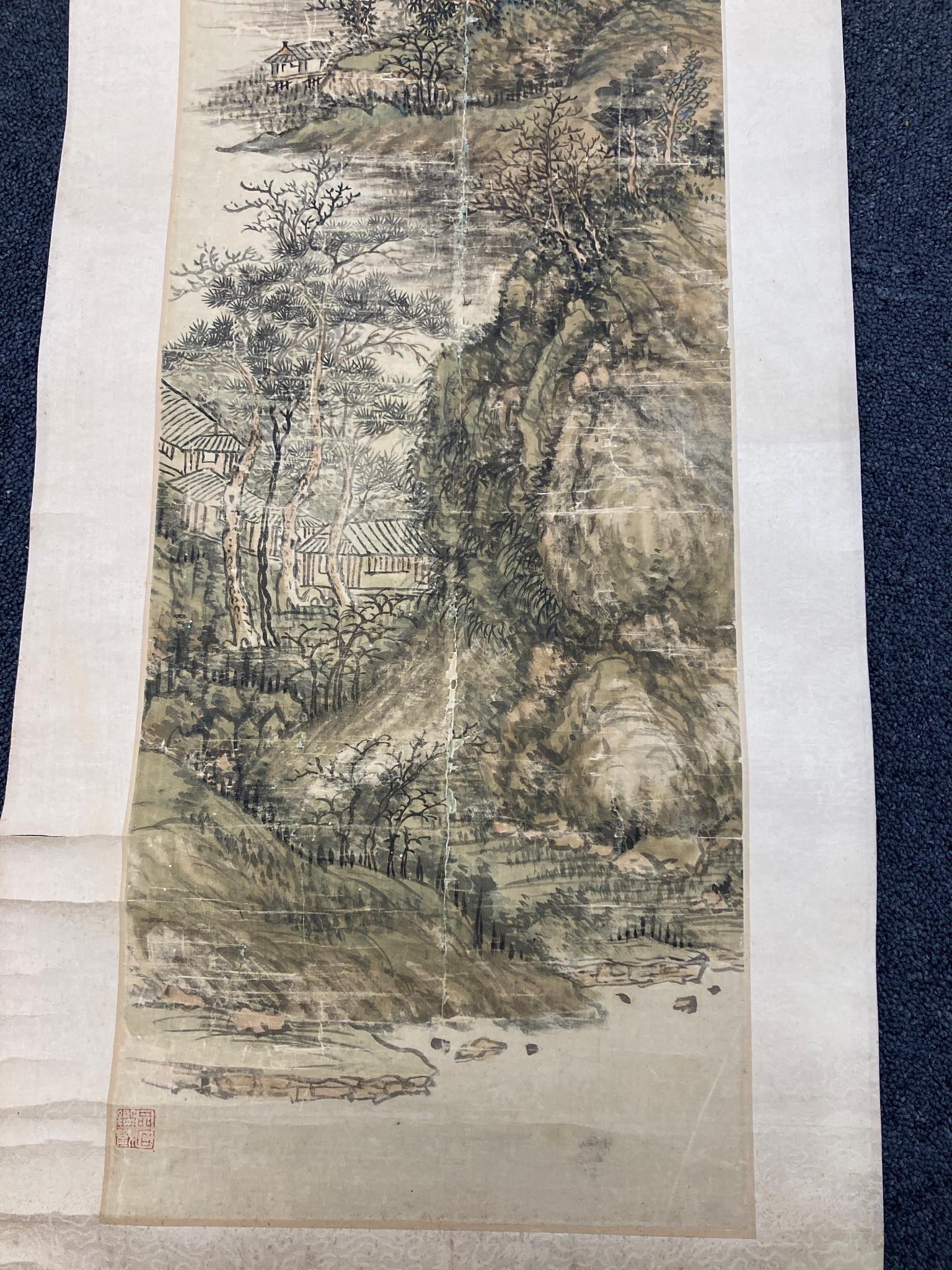 A Chinese landscape scroll painting on silk, Qing dynasty inscribed and signed, artist’s seal and collector’s seal lower left, image 139cm x 27.5cm, remounted